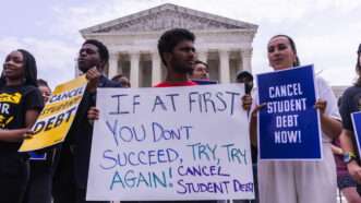 Protesters stand outside the U.S. Supreme Court building with signs calling for President Biden to continue trying to cancel student loan debt. | CNP/AdMedia/Newscom