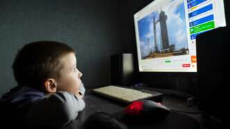 A young boy watches a SpaceX rocket launch on the Internet. | Cherokee4 | Dreamstime.com
