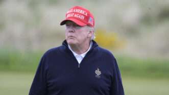 Trump in MAGA hat looking off into the distance | Wattie Cheung / MEGA / Newscom