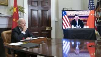 President Joe Biden sits in a room on a teleconference with China | Sarah Silbiger - Pool via CNP / MEGA / Newscom/RSSIL/Newscom