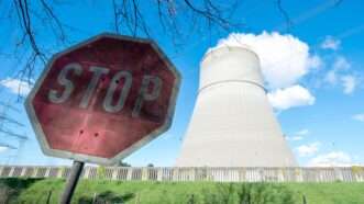A stop sign in the foreground, with a smokestack of the Emsland nuclear power plant in Lower Saxony, Germany, in the background. | CHINE NOUVELLE/SIPA/Newscom