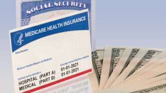 A Social Security card and a Medicare Card and seen next to  bills | Photo 179065850 © Steveheap | Dreamstime.com
